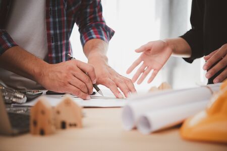 Engineers or architects is meeting for project working with model building and blueprint in working site.Construction and structure concept.の写真素材