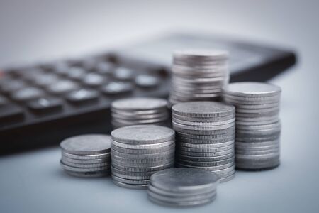copy space , money coins and stationary in white color style for money , banking , finance and business concept backgroundの写真素材