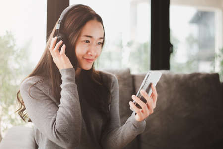 beautiful woman resting by playing smart phone ,watch movies, listen to music.
