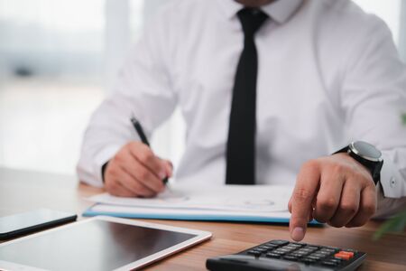 businessman or accountant professional manager working with finance document. Accountant signing finance report. Analysis working budget accounting startup economy man conceptの写真素材
