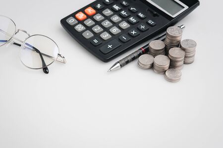 copy space , money coins and stationary in white color style for money , banking , finance and business concept backgroundの写真素材