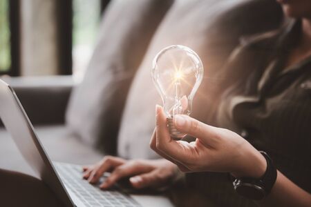 women holding light bulbs, ideas of new ideas with innovative technology and creativity.の写真素材