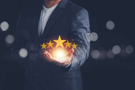 Customer evaluation feedback.men in suit Giving Positive Review for Client's Satisfaction Surveys.giving a five star rating. Service rating, satisfaction conceptの写真素材