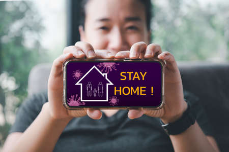 Outbreak alert notification on mobile. Stay at home advice to stop coronavirus COVID-19 spreading. Global pandemic Covid -19 prevention.Quarantine and warning, attention.の写真素材