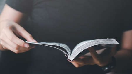 woman reading book at table, closeupの写真素材