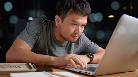 Asian man working with computer laptop.concept work form home, stay at home.night time.の写真素材