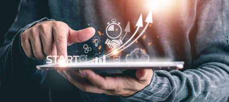 Startup concept with icon business and network connection on modern virtual interface from digital tablet.man touching on tablet.の写真素材