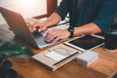 The concept works from home. Stay at home, it's easy to work.Asian Men Using a notebook computer To work at home.の写真素材
