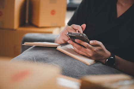 Online Selling or Online Shopping concept.Asian woman works at home by selling online and he is currently accepting and taking orders.business of seller merchant online ecommerce.の写真素材