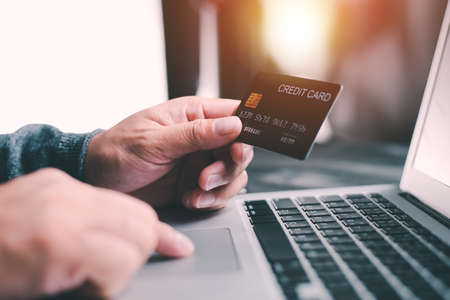 Hands holding credit card using Laptop payment shopping online with customer network connection via Omni channel system. Online shopping concept. people with technology.の写真素材