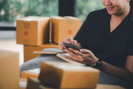 Online Selling or Online Shopping concept.Asian woman works at home by selling online and he is...