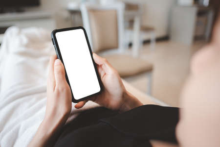 patient female using smartphone making payment while Lie on the patient's bed at the hospital.の写真素材