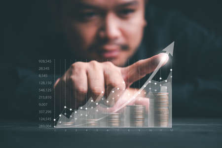 Finance and Investment concept.Money management and Financial chart. Businessman is touching a...