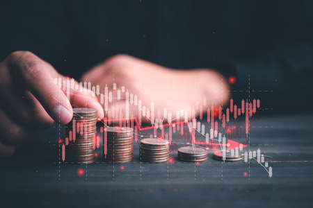 Chart with red down arrow with businessman stacking rows of coins. Falling growth in business. Graph down World economic recession concept.の写真素材