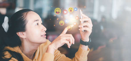 Social media and digital online concept, woman using smart phone in coffee shop. The concept of...