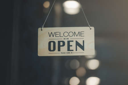 "Open" on cafe or restaurant hang on door at entrance.の写真素材