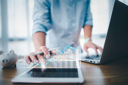 business finance technology and investment concept. Stock Market Investments Funds and Digital Assets. businessman analysing forex trading graph financial data. Business finance background.の写真素材