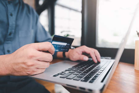 shopping online payment by using laptop.hands holding credit card and using laptop. online shopping concept.の写真素材