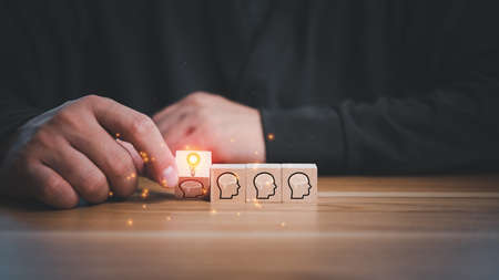 creative idea.Concept of idea and innovation. Hand of business man flips one revealing an idea from wooden cube blocks.の写真素材