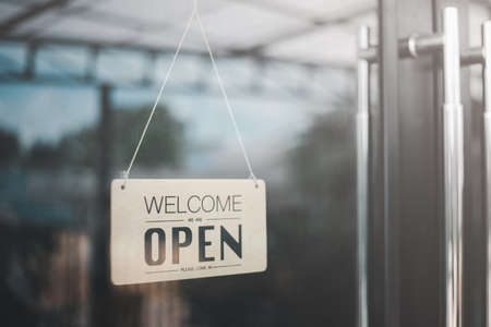 Open on cafe or restaurant hang on door at entrance.