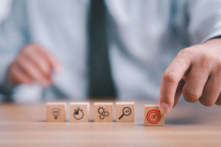 Business development strategy and action plan concept. hand arranging wood block with icon business strategy and Action plan.の写真素材