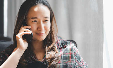 Asian woman talk to cellphoneの写真素材