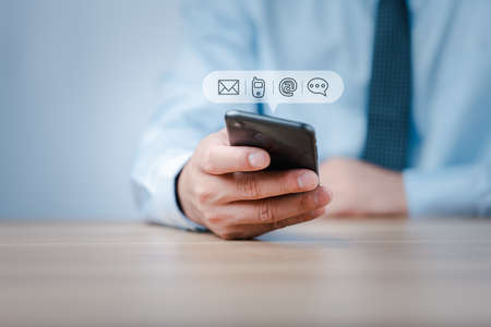 Customer support hotline Contact us people connection. Businessman using Smart Phone with the email, call phone, address, Chat message icons.の写真素材
