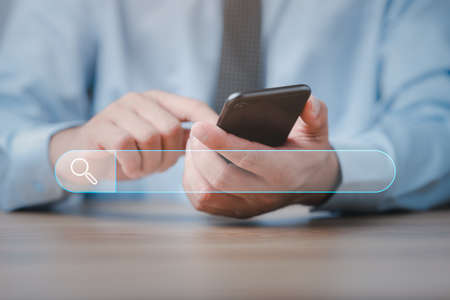 Data Search Technology Search Engine Optimization. male hands are using a smart phone to Searching for information.Using Search Console with your website.の写真素材