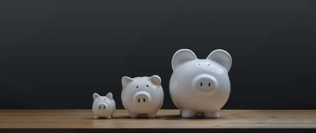 three white ceramic piggy bank on wood table. family Piggy Bankの写真素材