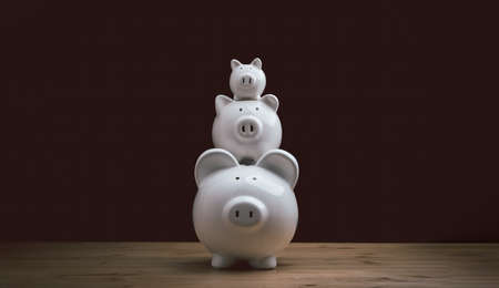 three white ceramic piggy bank on wood table. family Piggy Bankの写真素材