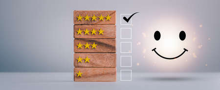 feedback rating and positive customer review experience, service and Satisfaction, wood block with 1 to 5 star icon to give satisfaction in service. rating very impressed. Mental Health Assessment.の写真素材