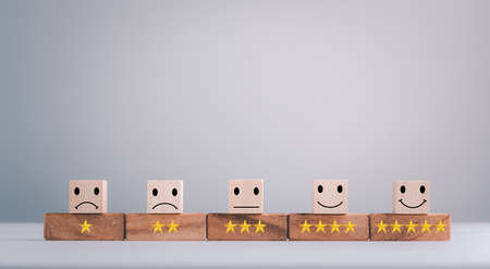 feedback rating and positive customer review experience, service and Satisfaction, wood block with 1 to 5 star icon to give satisfaction in service. rating very impressed. Mental Health Assessment.の写真素材