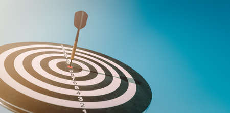business marketing as concept. Black dart arrow hitting in the target center of dartboard Target hit in the center.の写真素材