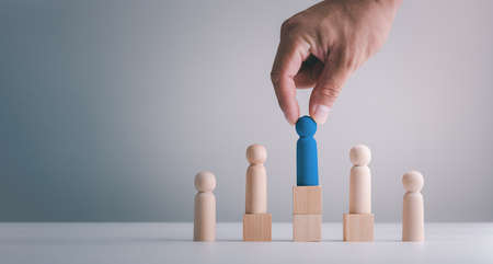 Businessman hand or Employer chooses takes in hand employee. Leader stands out from crowd. Looking for good worker. HR, HRM, HRD conceptsの写真素材