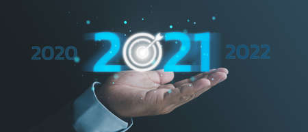 business target and goal on New year 2020 change to 2021 concept, hand holding 2021 virtual screen. new years business.の写真素材