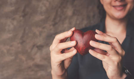 female hands holding red heart, world mental health day and world heart day, Life and health insurance, concept of love.の写真素材