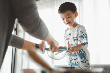 Asian Mother and son making cookies togetherの写真素材