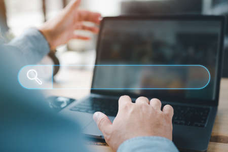 Data Search Technology Search Engine Optimization. man's hands are using a computer notebook to...