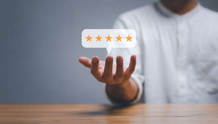 businessman showing Five stars rating popup on hand, positive customer Experience feedback and...