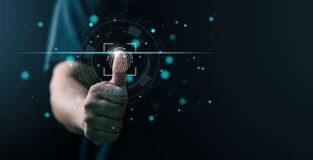 futuristic digital processing of biometric identification fingerprint scanner. concept of surveillance and security scanning of digital programs cyber futuristic applicationsの写真素材