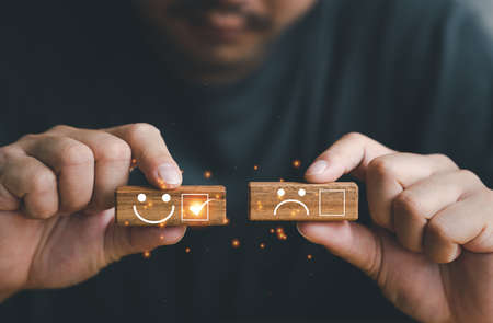 Customer service experience satisfaction evaluation concept, Close up customer hand choose smiley...
