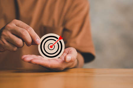 Targeting business concept. businessman clearly sets a target in his hand Planning for success. Set goals for better results. represent a challenge in business marketing as concept.の写真素材