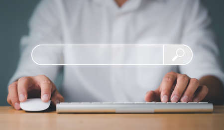 Data Search Technology Search Engine Optimization. man's hands are using a computer keyboard to...