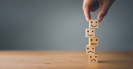 Customer service and Satisfaction concept ,Business people show a feedback with smile face wood cube...