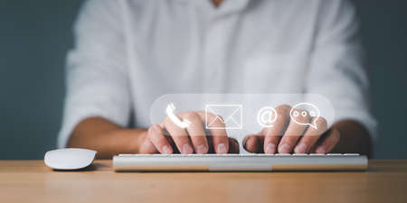 Customer support hotline Contact us people connection. Businessman using computer keyboard with the...