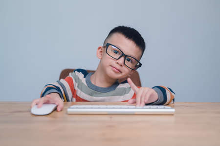 smart kids, Cute Asian Boy using a mouse and computer keyboard, homeschooling, online study, home...