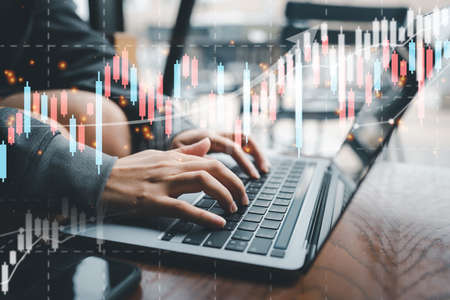 Businesswoman hands or stock trader analyzing stock graph chart forex charts by indicator using laptop to buy or sell stock, double exposure graph, internet trading, investmentの写真素材
