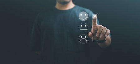 Customer service and Satisfaction concept ,Business people are touching the virtual screen on the happy Smiley face icon to give satisfaction in service. rating very impressed.の写真素材
