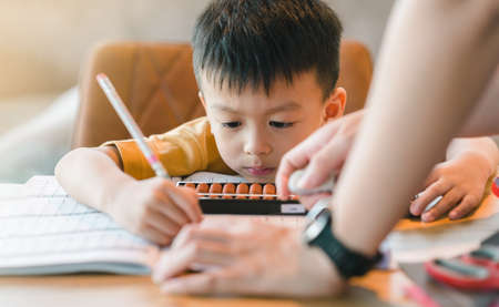 Asian boy Learning math with an abacus, education concept, home school, Social distancing, stay home, online learning class study math.の写真素材