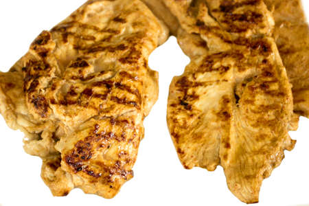 grilled chicken steak fillet with pan lines only on white backgroundの写真素材
